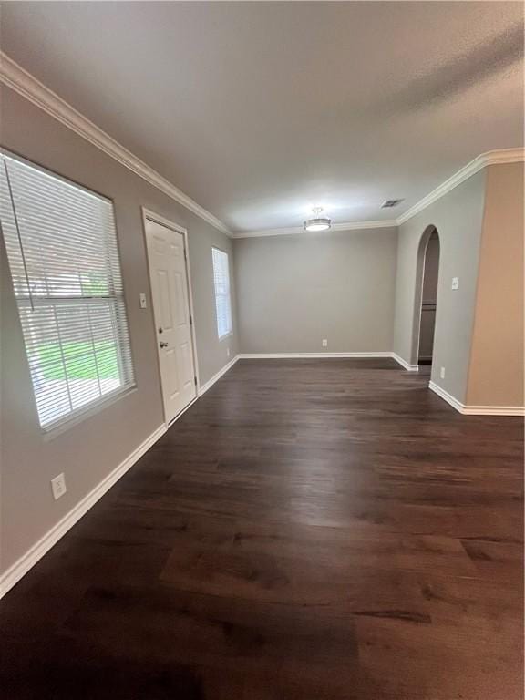 630 Sharon Dr, Corpus Christi, TX 78412 - spare room featuring ornamental molding, dark wood finished floors, and arched walkways