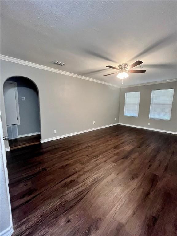 630 Sharon Dr, Corpus Christi, TX 78412 - spare room with crown molding, ceiling fan, dark wood finished floors, arched walkways, and a textured ceiling