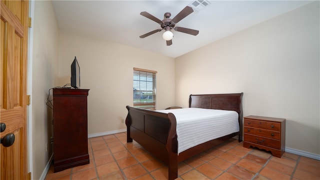 bedroom with ceiling fan and tile patterned flooring