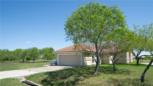 view of front of house with a garage and a front yard