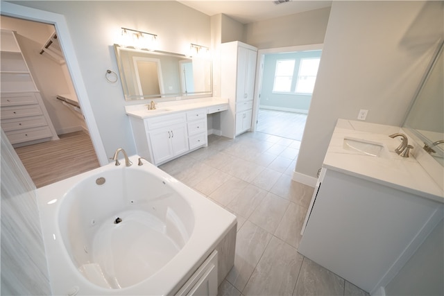 bathroom featuring vanity and a washtub