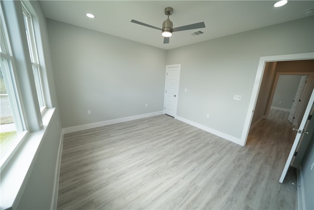 spare room with ceiling fan and light hardwood / wood-style flooring