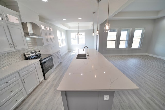 kitchen featuring white cabinetry, stainless steel range with electric cooktop, and a large island