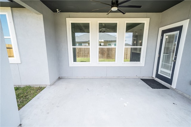 property entrance featuring a patio area and ceiling fan