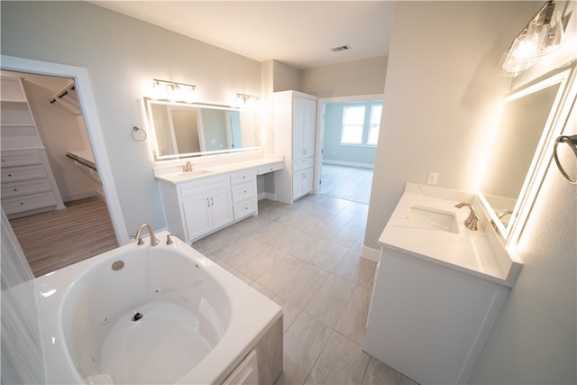 bathroom featuring tile patterned flooring, vanity, and a bathtub