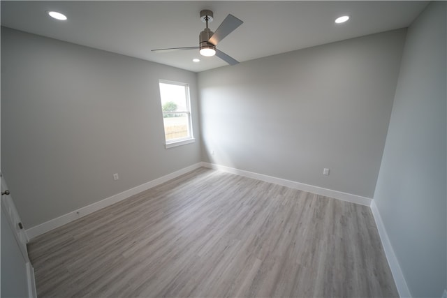 spare room featuring ceiling fan and light hardwood / wood-style flooring