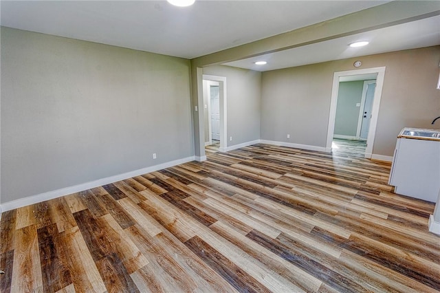 2221 Cleo St, Corpus Christi, TX 78405 - unfurnished room featuring a sink, wood finished floors, baseboards, and recessed lighting