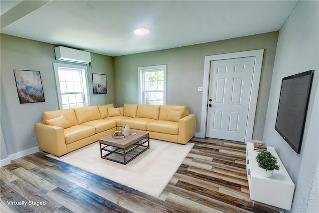 2221 Cleo St, Corpus Christi, TX 78405 - living area with a wall mounted air conditioner, wood finished floors, and baseboards