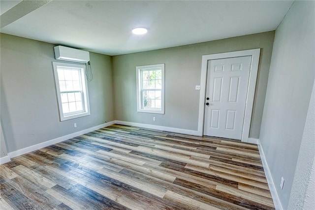 2221 Cleo St, Corpus Christi, TX 78405 - foyer entrance with a wall mounted AC, wood finished floors, and baseboards
