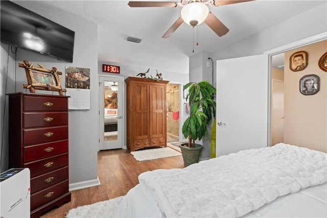 bedroom featuring ceiling fan, wood-type flooring, and lofted ceiling