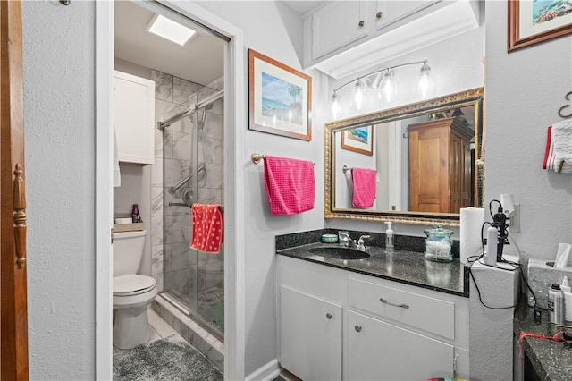 bathroom with vanity, an enclosed shower, tile patterned floors, and toilet