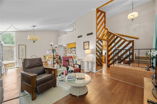 6845 Aswan Dr, Corpus Christi, TX 78412 - living room with a chandelier, wood finished floors, stairway, and a towering ceiling