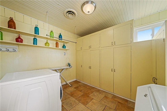 305 Circle Dr, Corpus Christi, TX 78412 - laundry room with cabinet space, washer and clothes dryer, light stone finish flooring, and wood ceiling