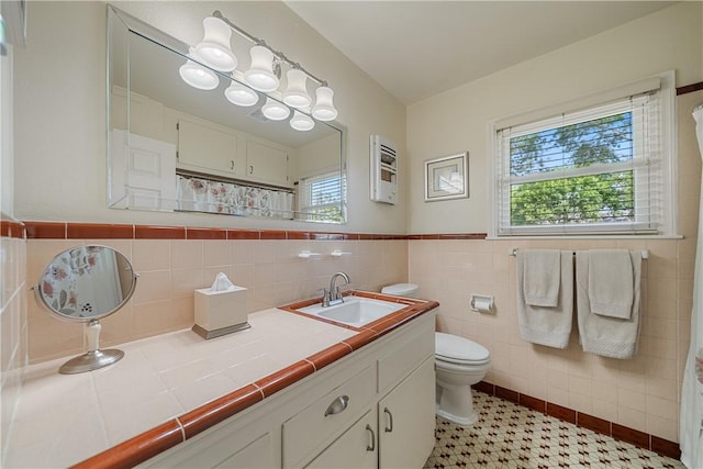 305 Circle Dr, Corpus Christi, TX 78412 - bathroom with vanity, toilet, plenty of natural light, tile walls, and curtained shower