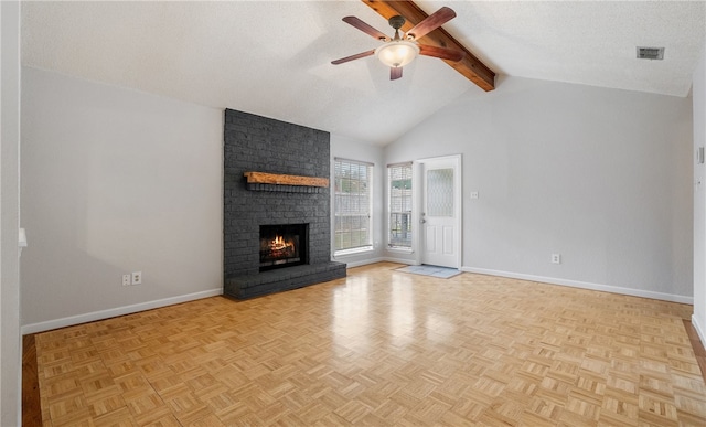 unfurnished living room featuring light parquet flooring, a brick fireplace, a textured ceiling, and beam ceiling