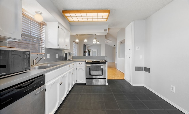 kitchen with white cabinetry, appliances with stainless steel finishes, decorative light fixtures, and sink