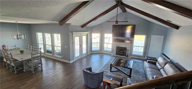 living room featuring a fireplace, plenty of natural light, ceiling fan with notable chandelier, and dark hardwood / wood-style flooring