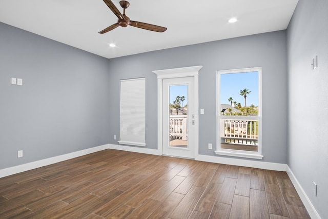 spare room with ceiling fan and dark hardwood / wood-style floors