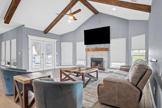 112 Dolphin Ct, Aransas Pass, TX 78336 - living room with beamed ceiling, light wood-type flooring, ceiling fan, french doors, and high vaulted ceiling