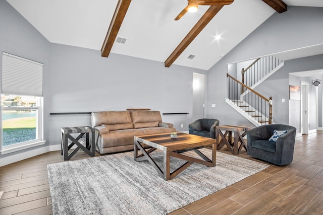 living room with high vaulted ceiling, beamed ceiling, hardwood / wood-style flooring, and ceiling fan