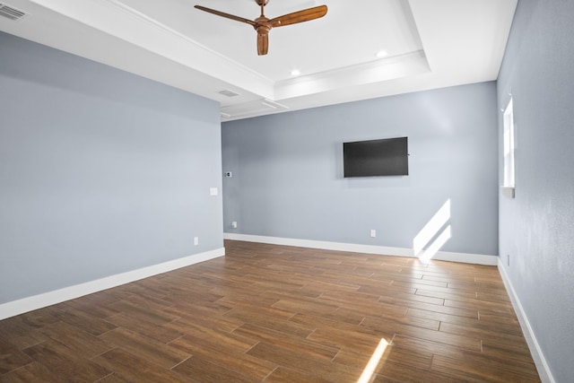 unfurnished room with crown molding, wood-type flooring, ceiling fan, and a raised ceiling