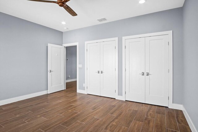 112 Dolphin Ct, Aransas Pass, TX 78336 - unfurnished bedroom featuring multiple closets, wood finished floors, baseboards, recessed lighting, and ceiling fan