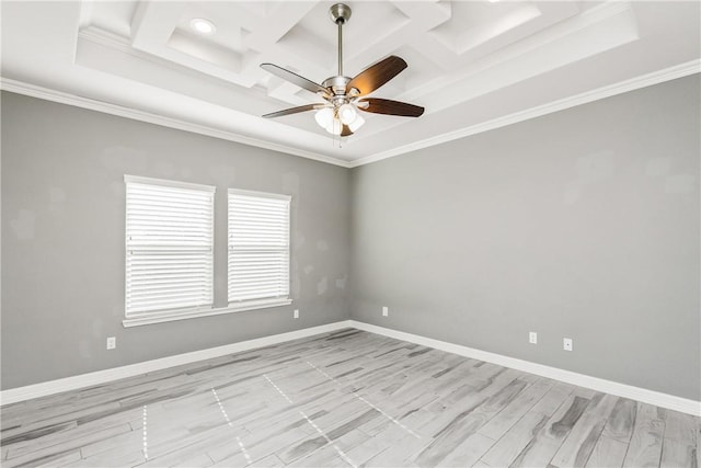 spare room featuring baseboards, coffered ceiling, and crown molding