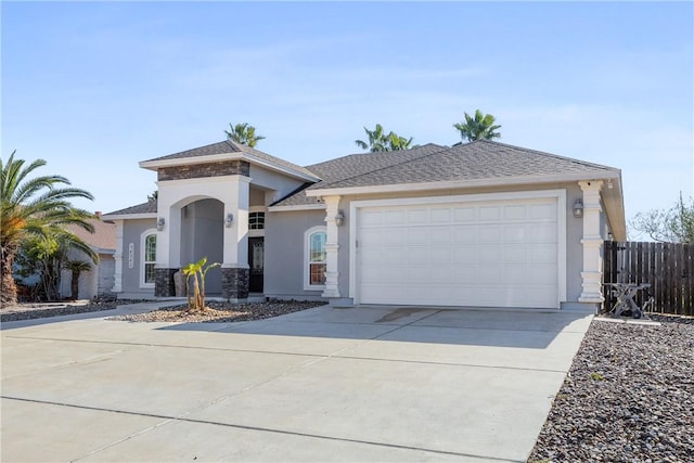 view of front of house featuring driveway, a garage, a shingled roof, fence, and stucco siding