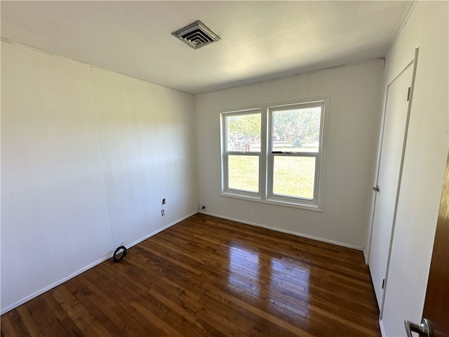 interior space featuring wood-type flooring, visible vents, and baseboards