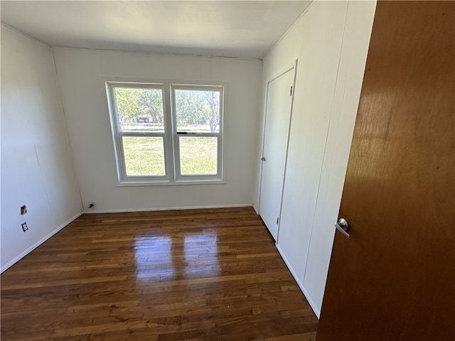 unfurnished bedroom featuring baseboards and wood finished floors