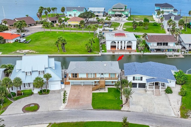 aerial perspective of suburban area with a nearby body of water