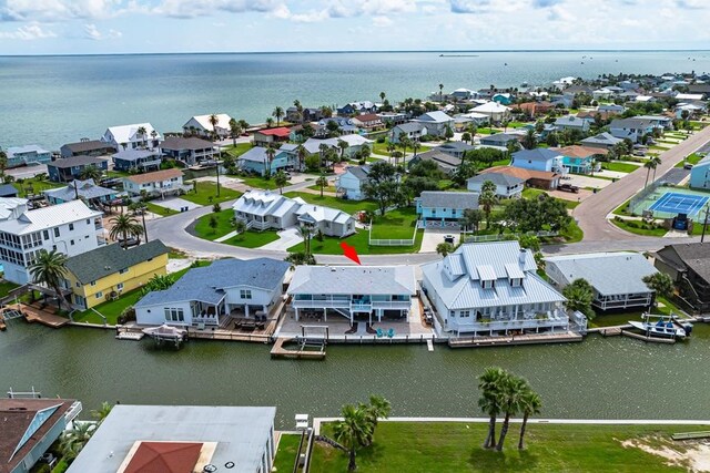 aerial perspective of suburban area with a nearby body of water