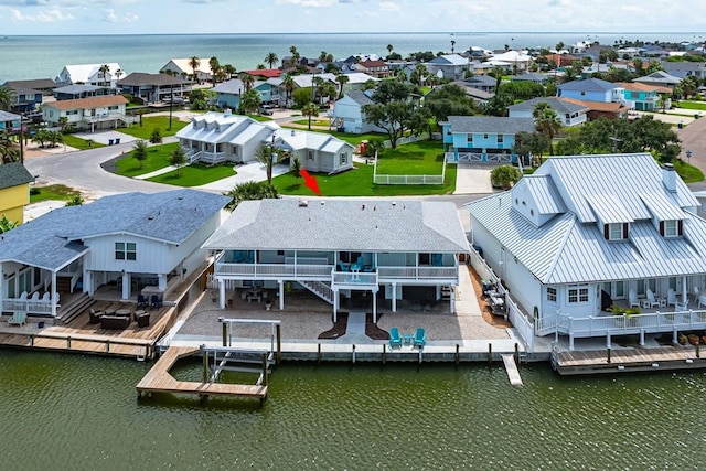 drone / aerial view with a residential view and a water view