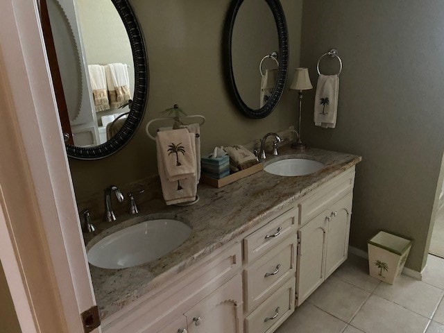bathroom with tile patterned floors and double vanity