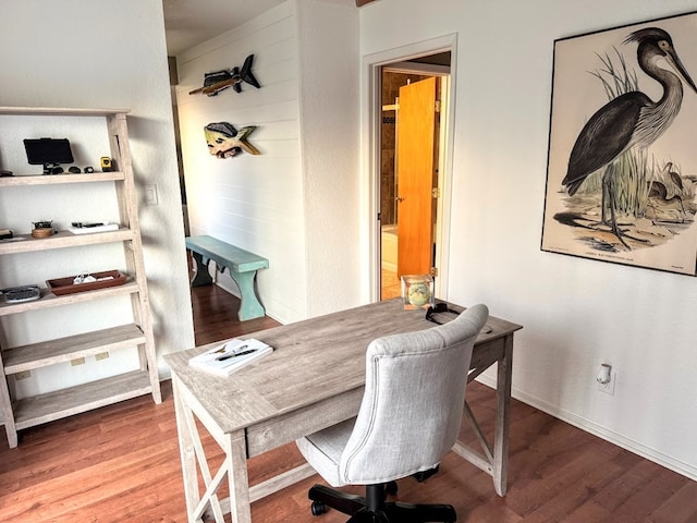 office area featuring baseboards and wood finished floors