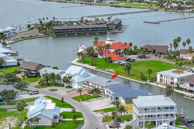 dock area with stairs, a deck with water view, a patio area, and fence