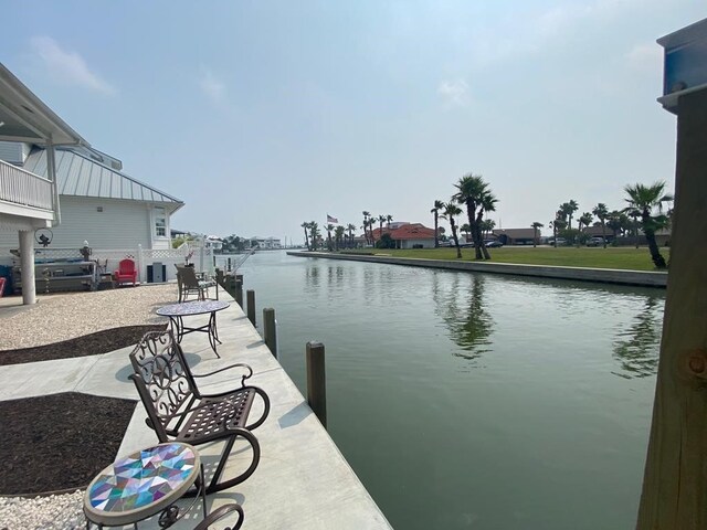 dock featuring boat lift and a water view