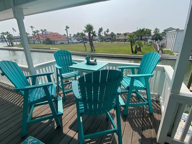 wooden deck featuring a residential view and a water view