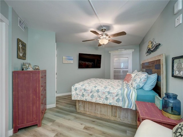 bedroom with ceiling fan and light hardwood / wood-style flooring