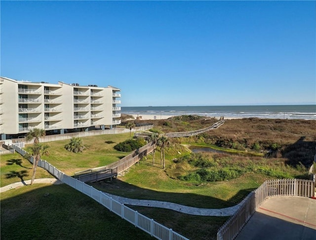 bird's eye view with a water view and a beach view