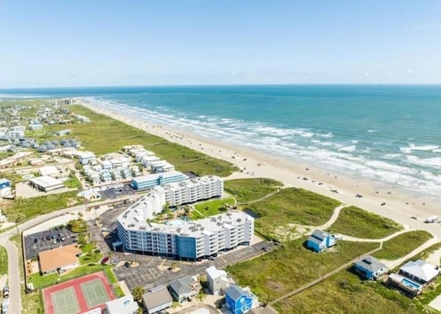 bird's eye view featuring a water view and a beach view