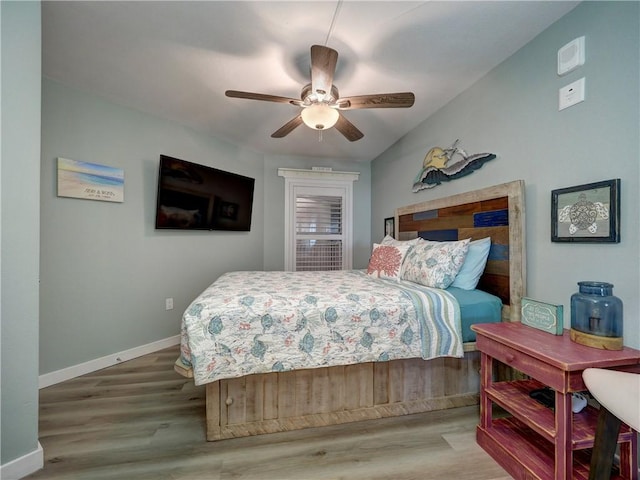 bedroom with light wood-type flooring, ceiling fan, and lofted ceiling