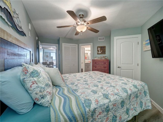 bedroom with ensuite bathroom, ceiling fan, and hardwood / wood-style flooring