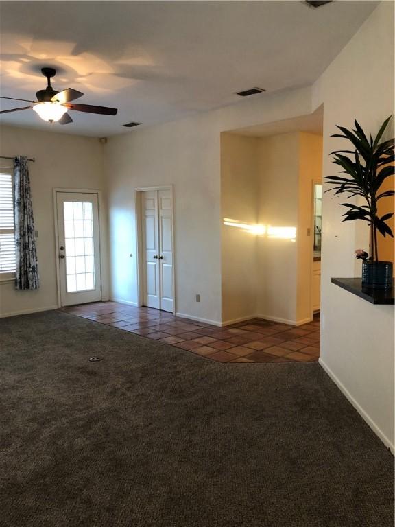 tiled empty room with ceiling fan