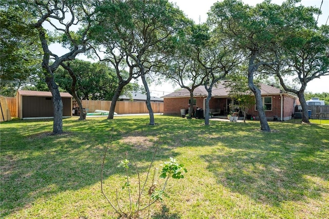 109 Starlight, Ingleside, TX 78362 - view of yard with a fenced backyard, an outdoor structure, and a shed