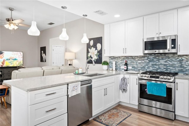 109 Starlight, Ingleside, TX 78362 - kitchen with a peninsula, a sink, stainless steel appliances, open floor plan, and visible vents