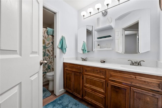 109 Starlight, Ingleside, TX 78362 - full bathroom featuring double vanity, toilet, wood finished floors, and a sink