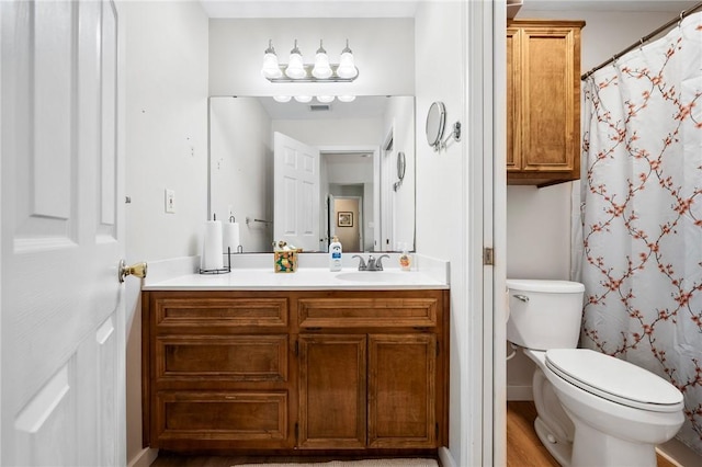 109 Starlight, Ingleside, TX 78362 - full bathroom featuring vanity, toilet, visible vents, and wood finished floors