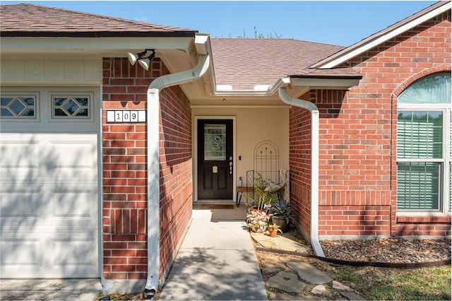 109 Starlight, Ingleside, TX 78362 - property entrance featuring a shingled roof, brick siding, and an attached garage