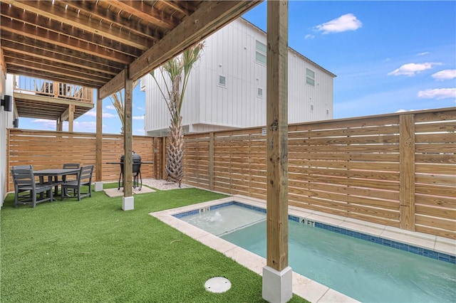 view of pool featuring grilling area and a yard